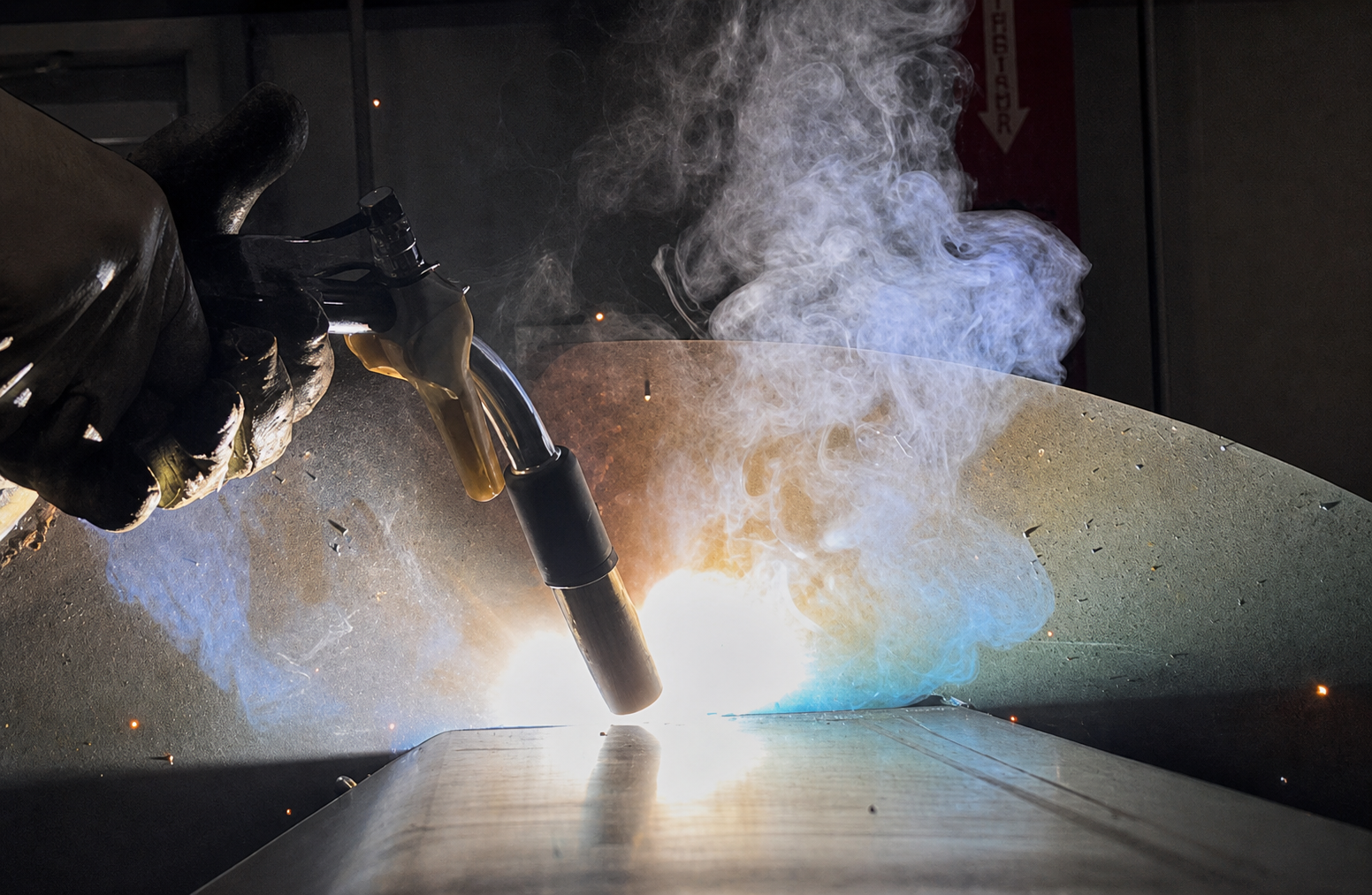 Welder with Sonibel Instruments sensor mounted on torch